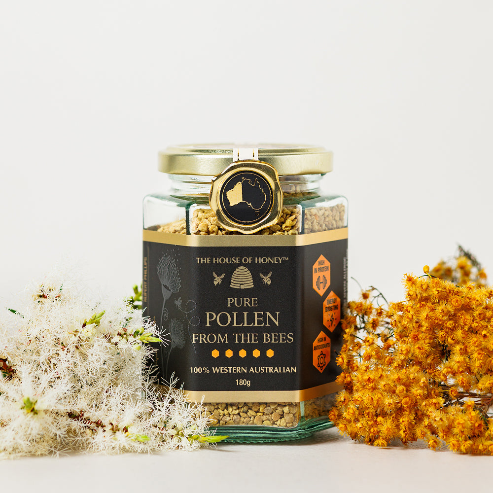 Jar of pure pollen from bees with decorative flowers on a light background