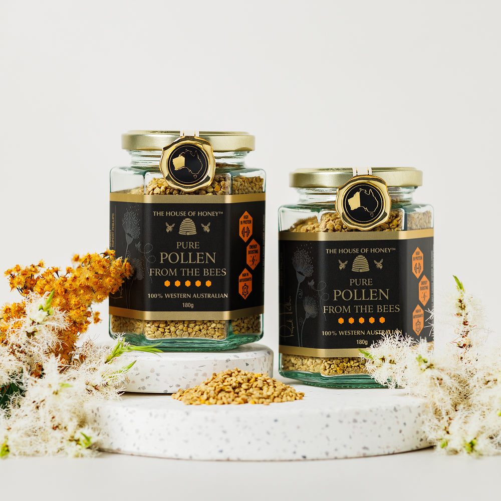 Two jars of 'Pure Pollen from the Bees' with decorative flowers on a light background